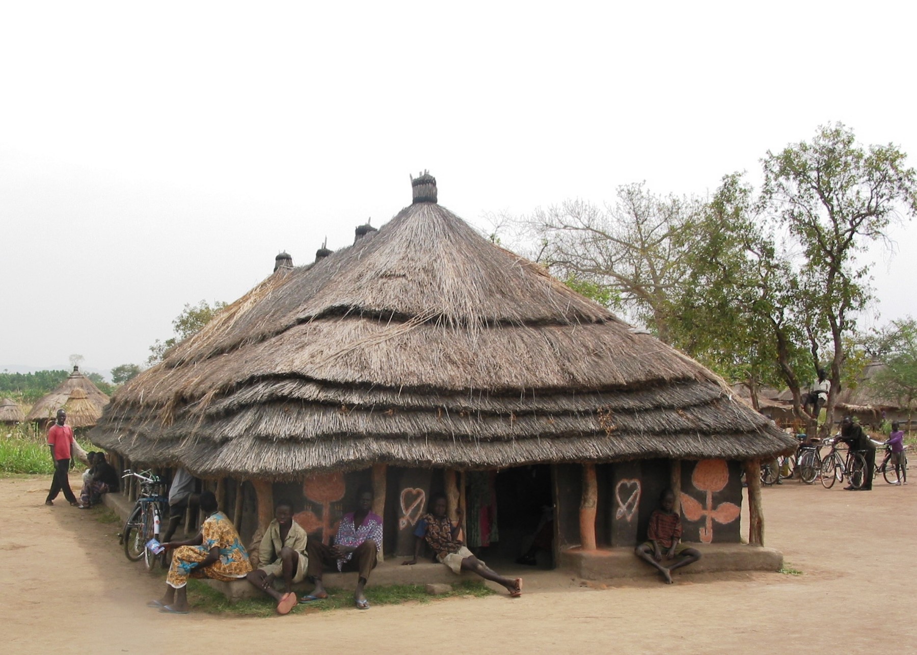 Large meeting-style hut with people Large meeting hut with people