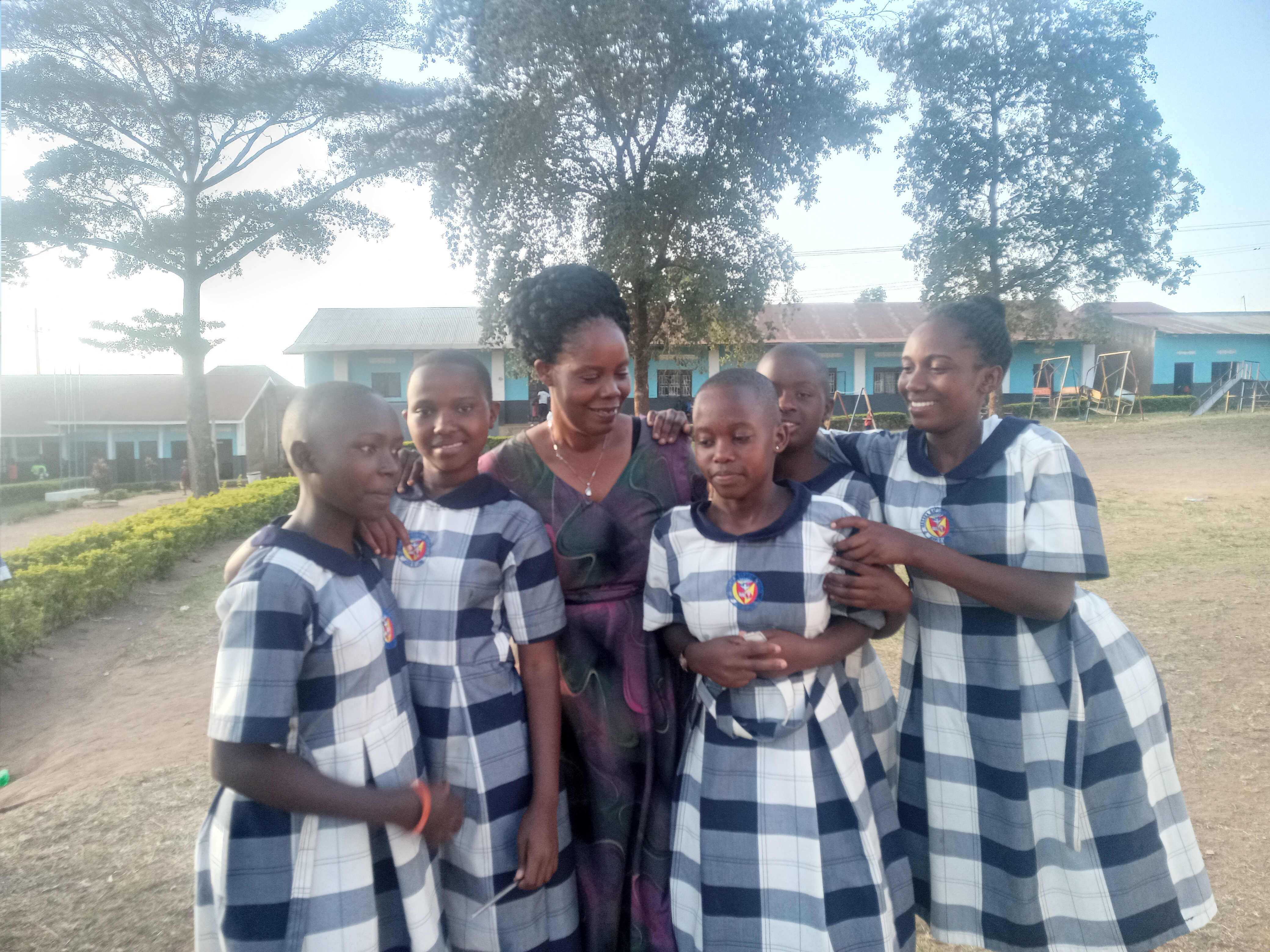 Adult woman with school girls in blue and white plaid uniforms