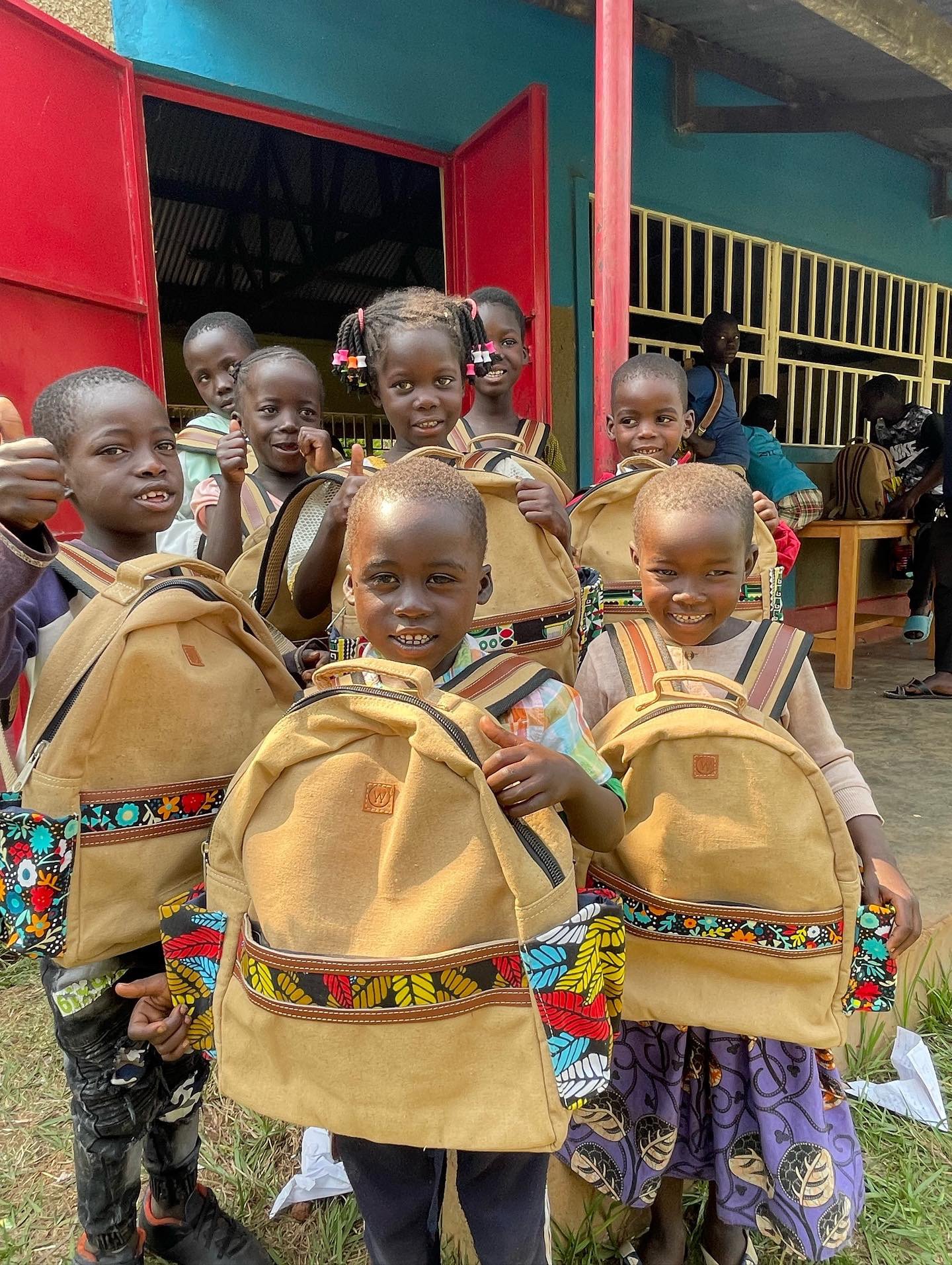 Students holding decorated backpacks