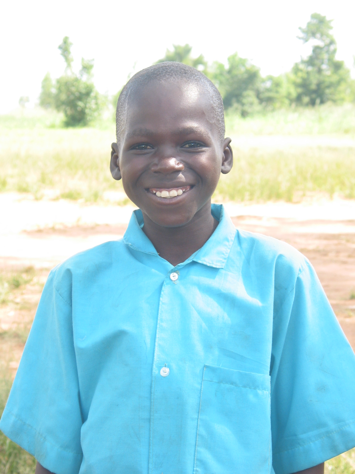 Young boy smiling in blue school uniform