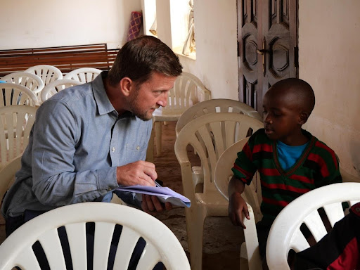 Caleb and student Caleb eating visiting young student