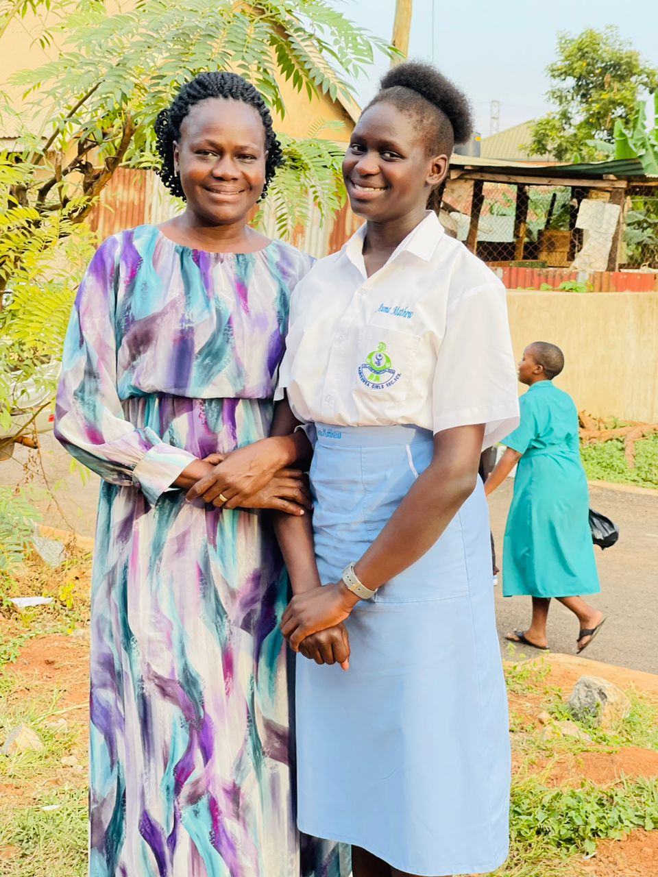 Carol and daughter Woman and adult daughter facing camera smiling