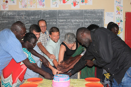 Adults and Catharine with cake