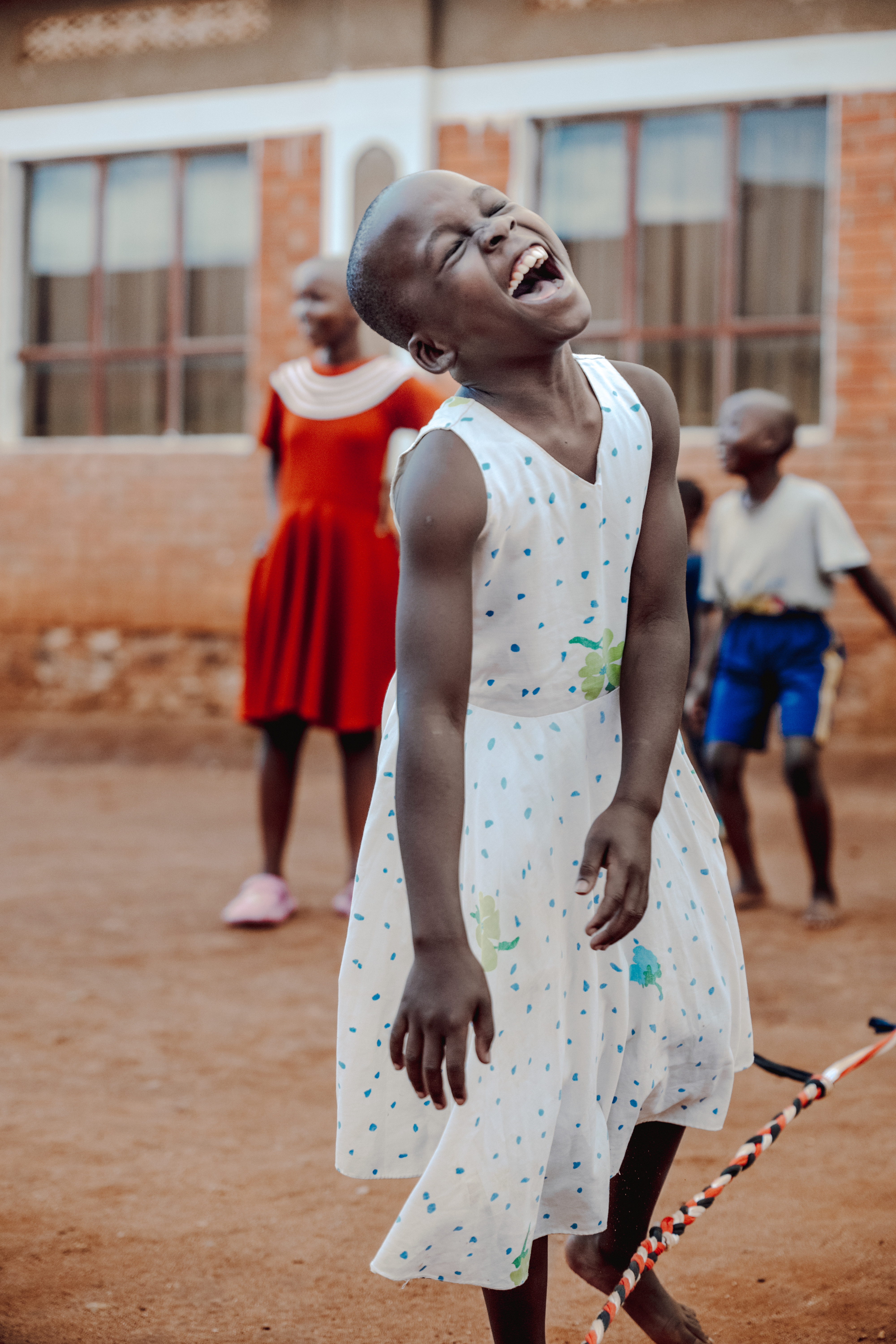 Young girl head back laughing