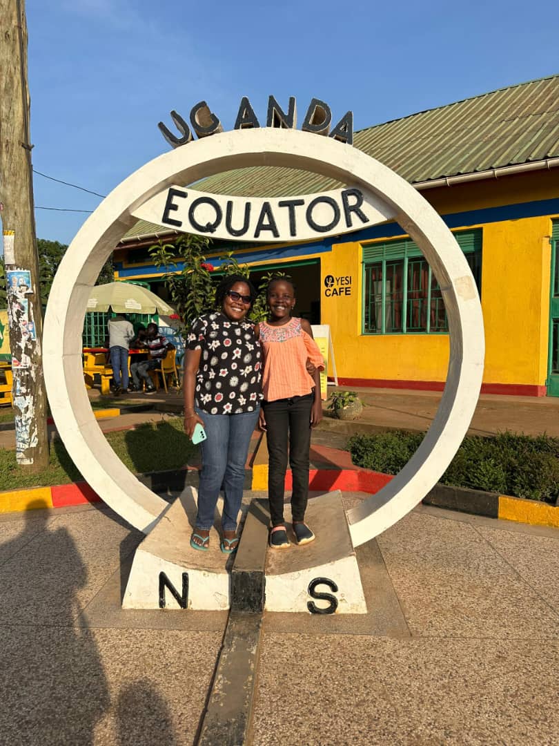 Lonnah and Abigail Woman and daughter in Equator sign