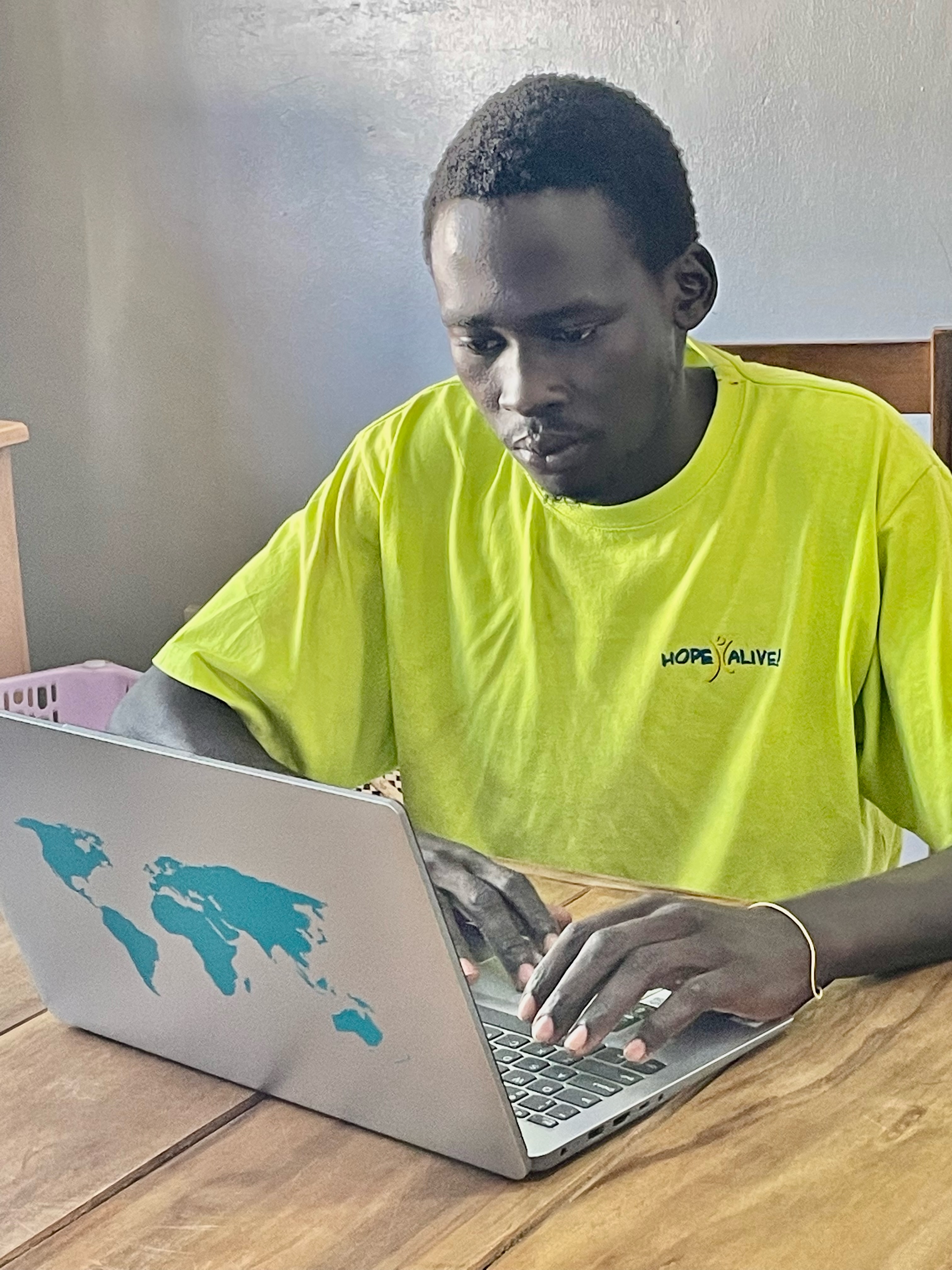 Michael using donated laptop college age student using laptop