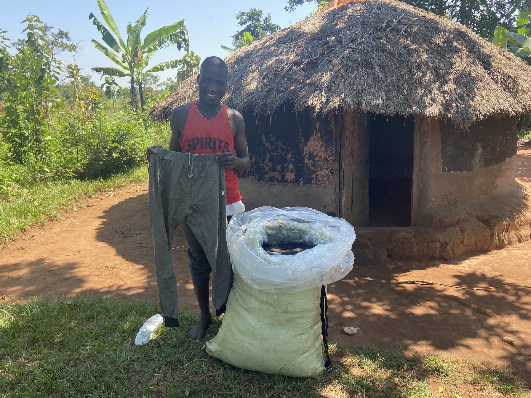 Man with a large plastic bag of clothing