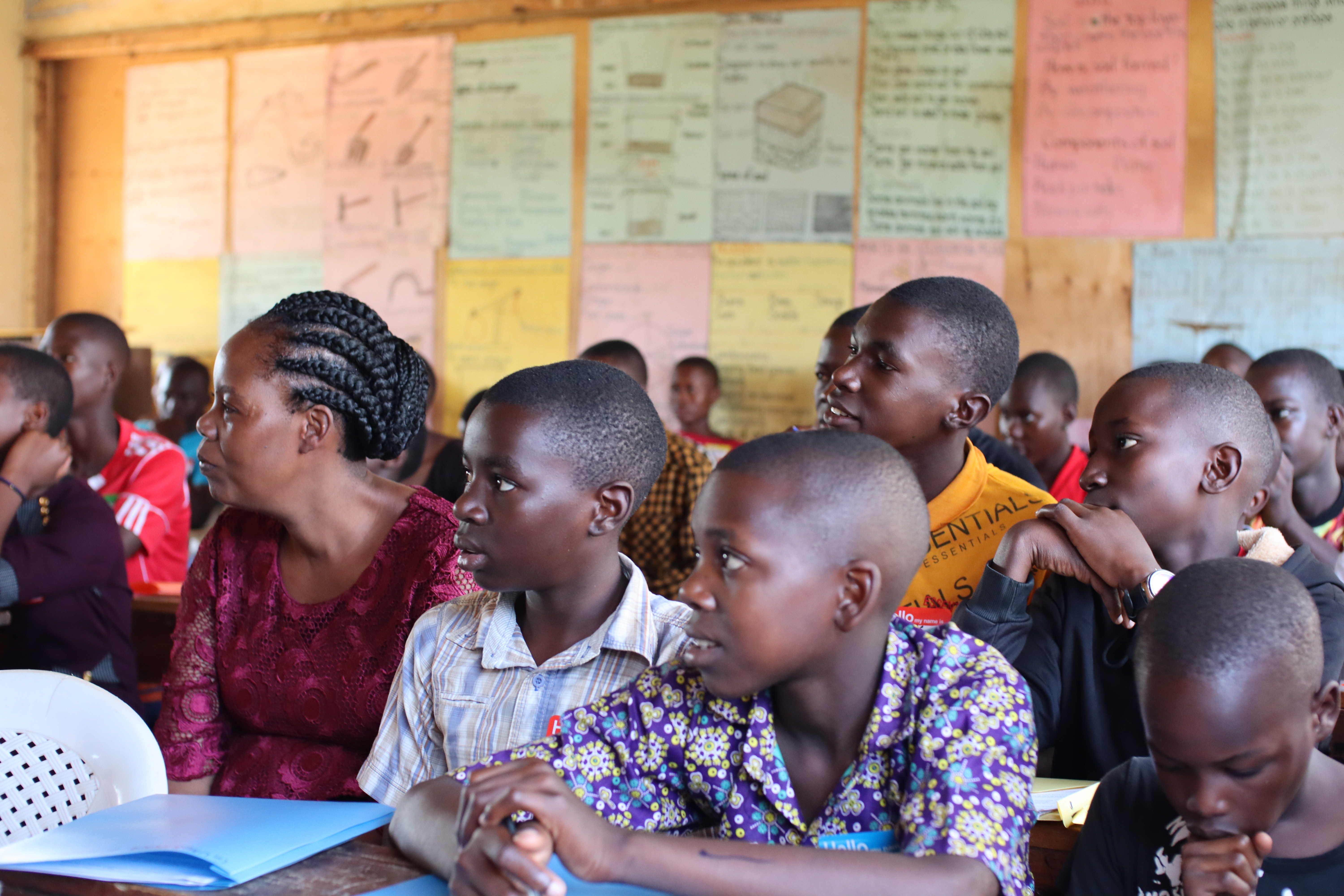 woman sitting in classroom alongside students