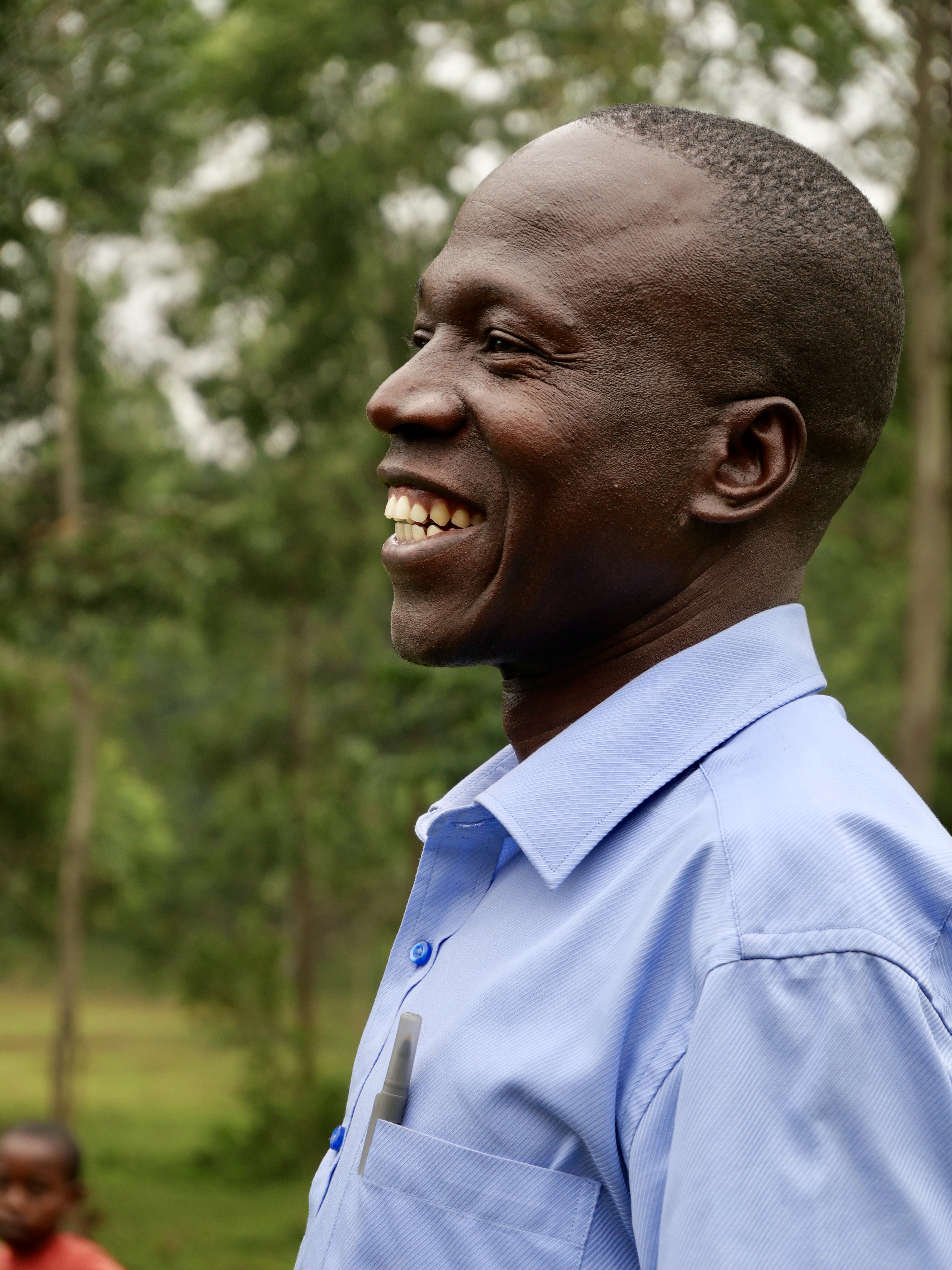 Smiling man in profile, looking left