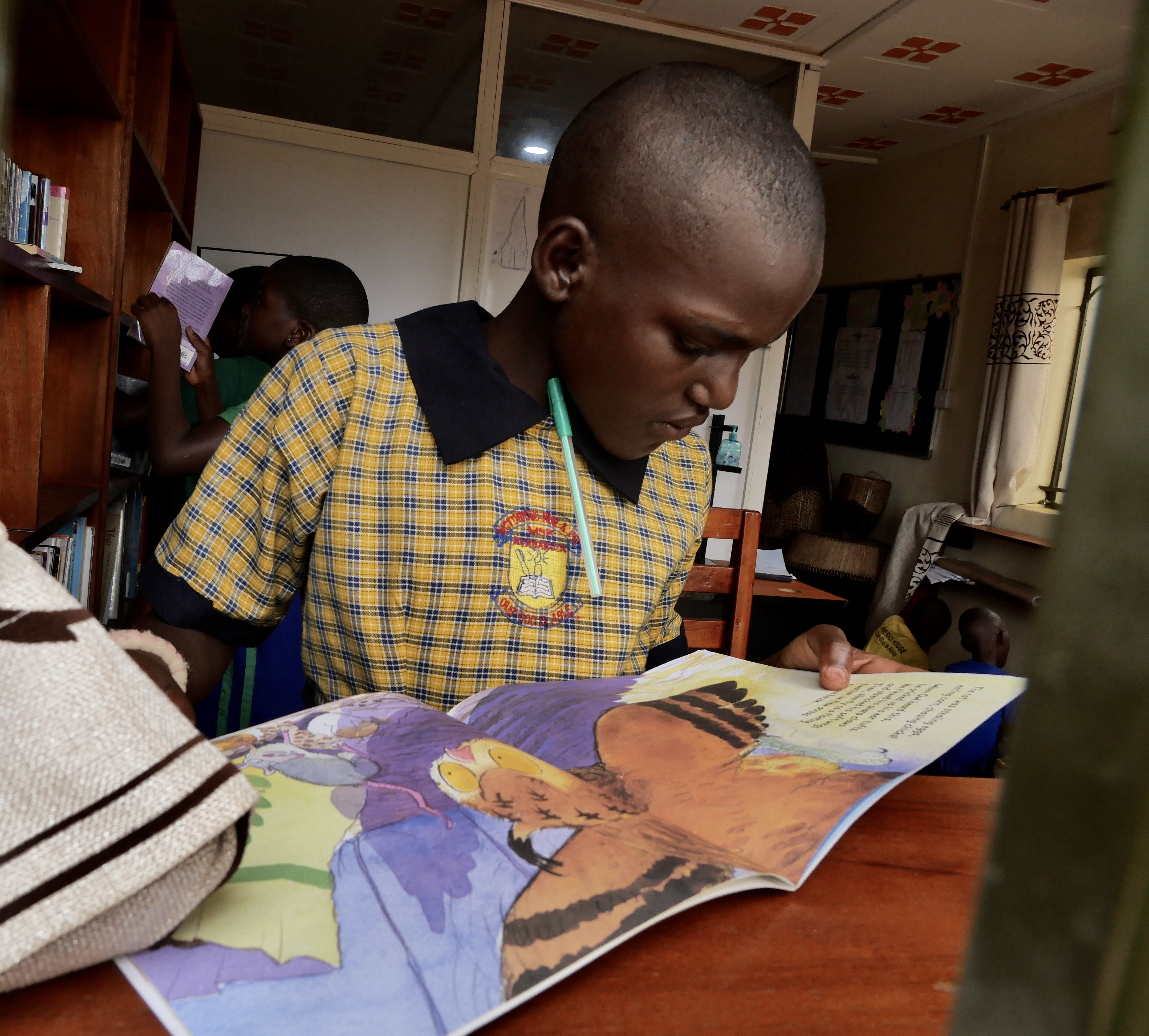 Child in a library looking at a picture book