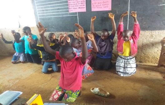 Large number of students on knees worshipping