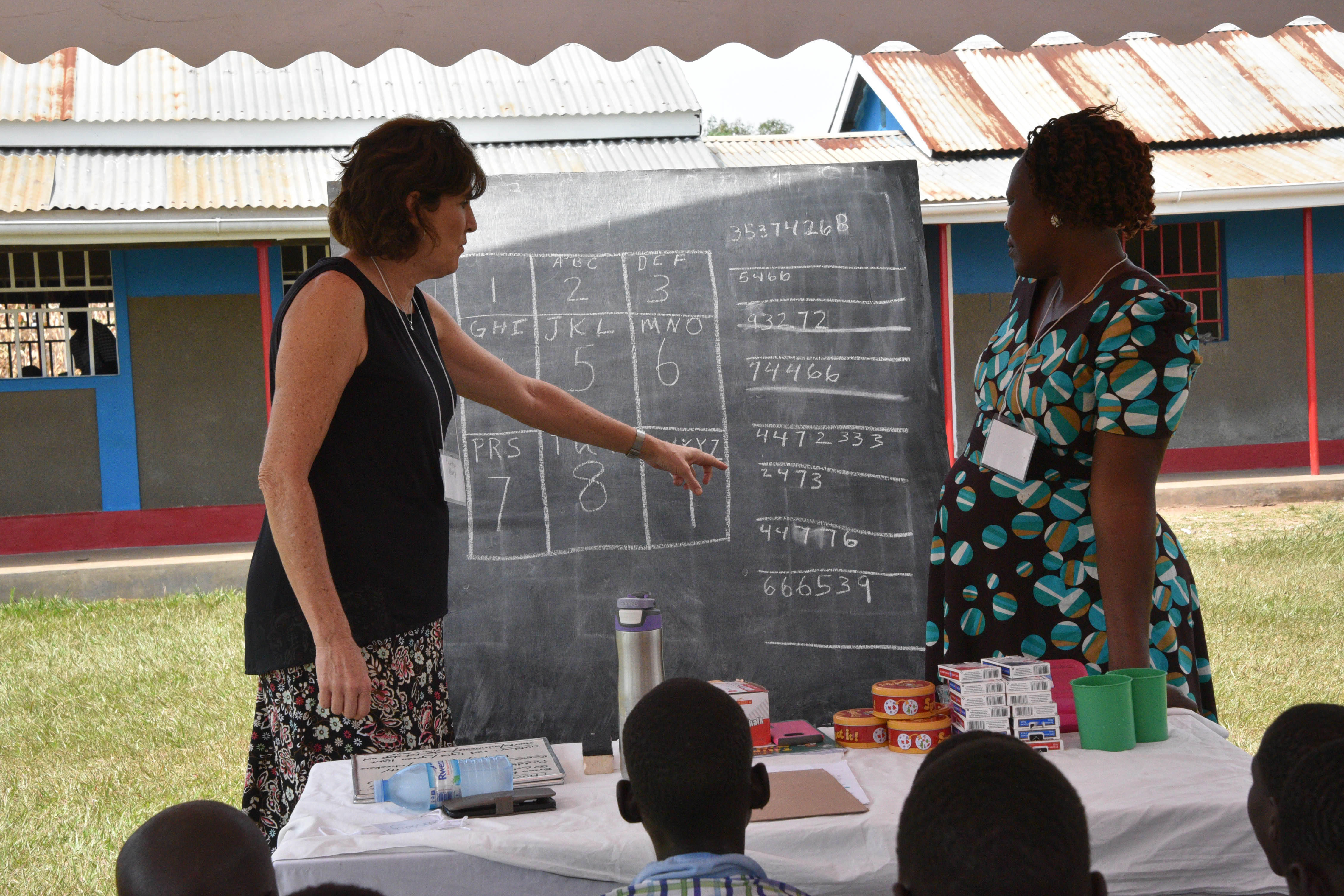 American and mentor in front of group with math game